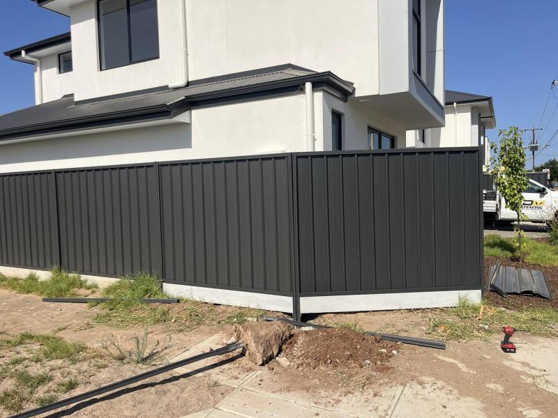 Monument Colorbond boundary on a new build, set on a concrete plinth
